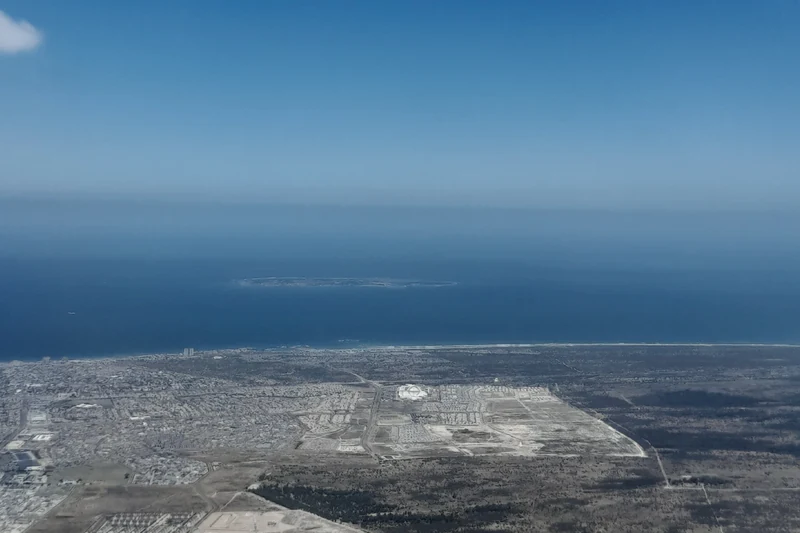 An aerial view of Robben Island and the surrounding sea.