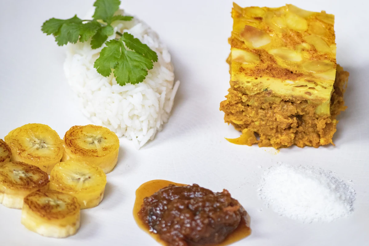 Bobotie with rice, banana and accompaniments.
