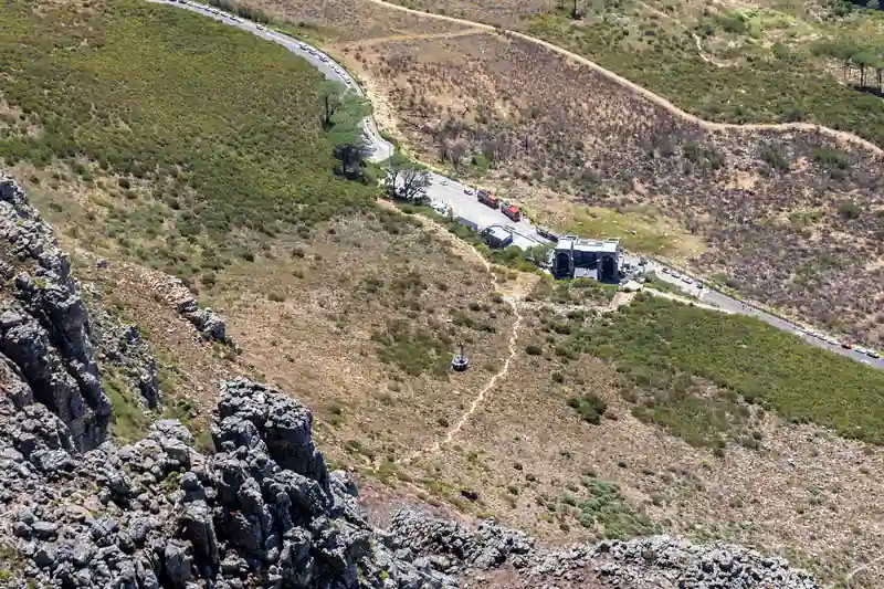 The Table Mountain cableway station below rocky mountain slopes.