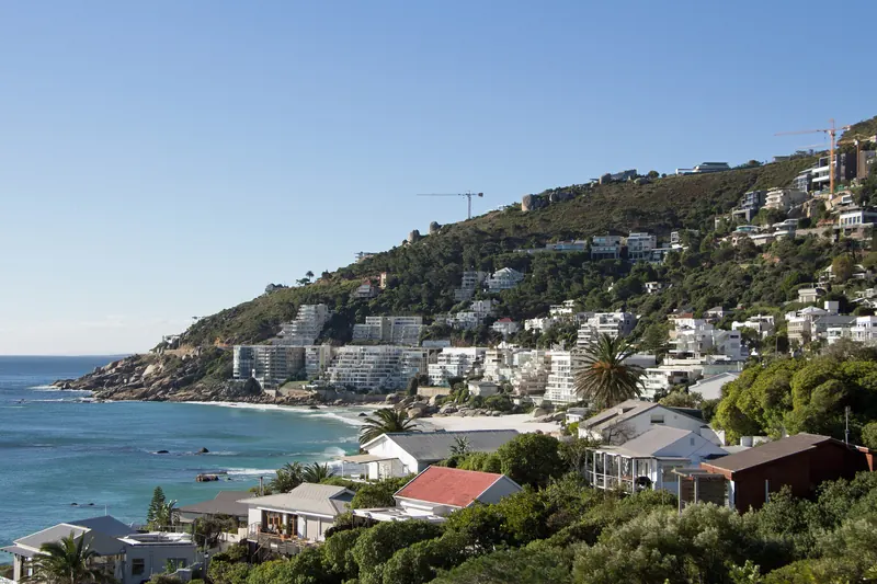 Clifton Fourth Beach, with coastal houses and the Atlantic beyond.