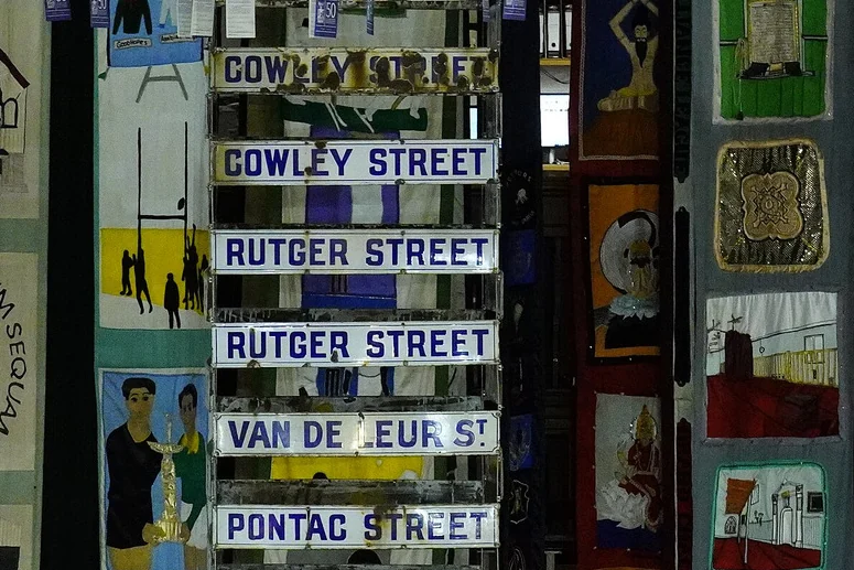 Hanging banners and street signs inside District Six Museum.